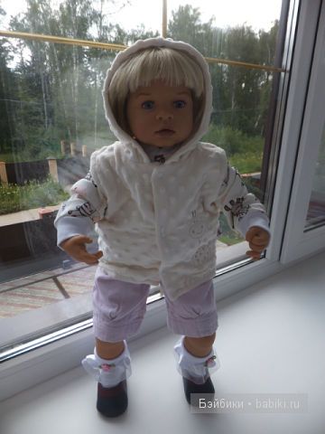 Мари стоит в окне