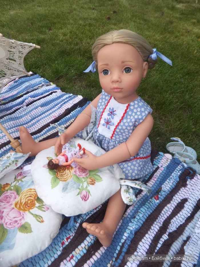 Нюра с куколкой, на коврике