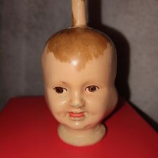 Голова Треxликой куклы