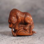 Нэцкэ "Собака, переворачивающая корзину" Самшит, ручная резьба